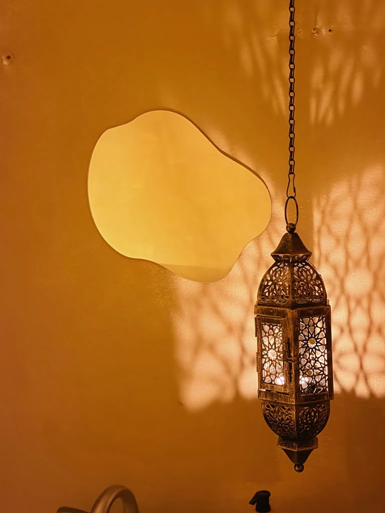 Warm lantern glowing in the Greens Wellness interior